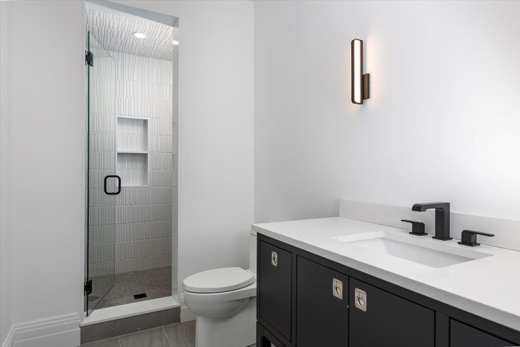 222 Warren Street Brookline, MA 02445 - Photo 31 of 33 a bathroom with a sink a toilet and shower