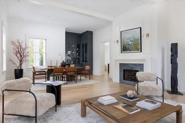 a living room with furniture a fireplace and a table