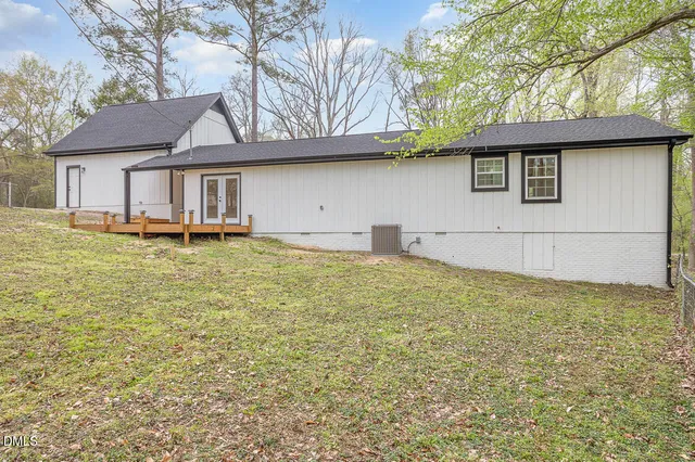 a house that has a large pool in front of it