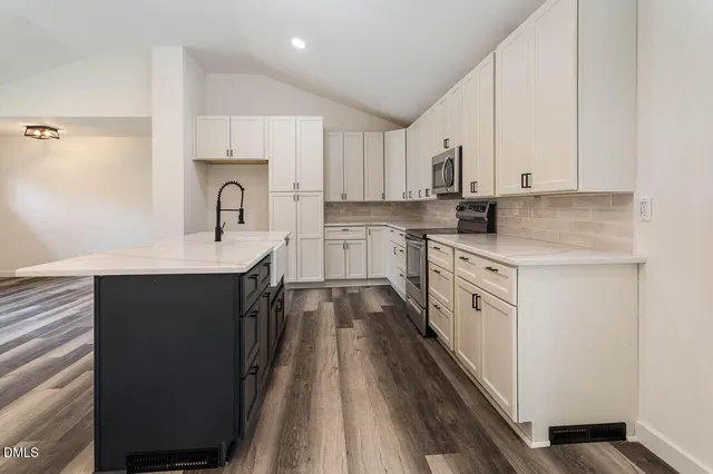 a kitchen with a sink stove top oven and cabinets