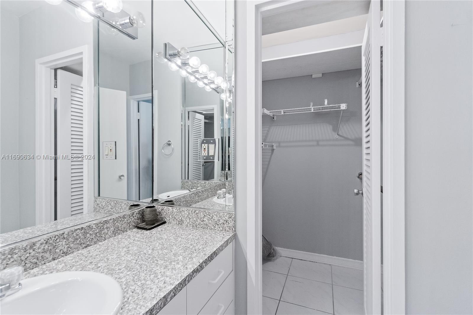 100 Lincoln Road, Unit 1016 Miami Beach, FL 33139 - Photo 13 of 25 a bathroom with a granite countertop sink and a mirror