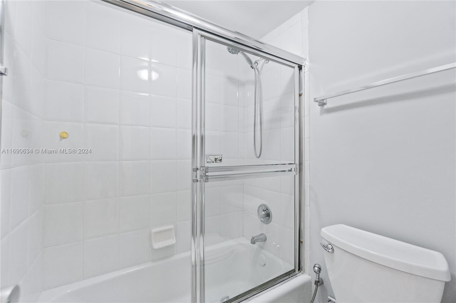 100 Lincoln Road, Unit 1016 Miami Beach, FL 33139 - Photo 14 of 25 a bathroom with a shower a toilet and a window
