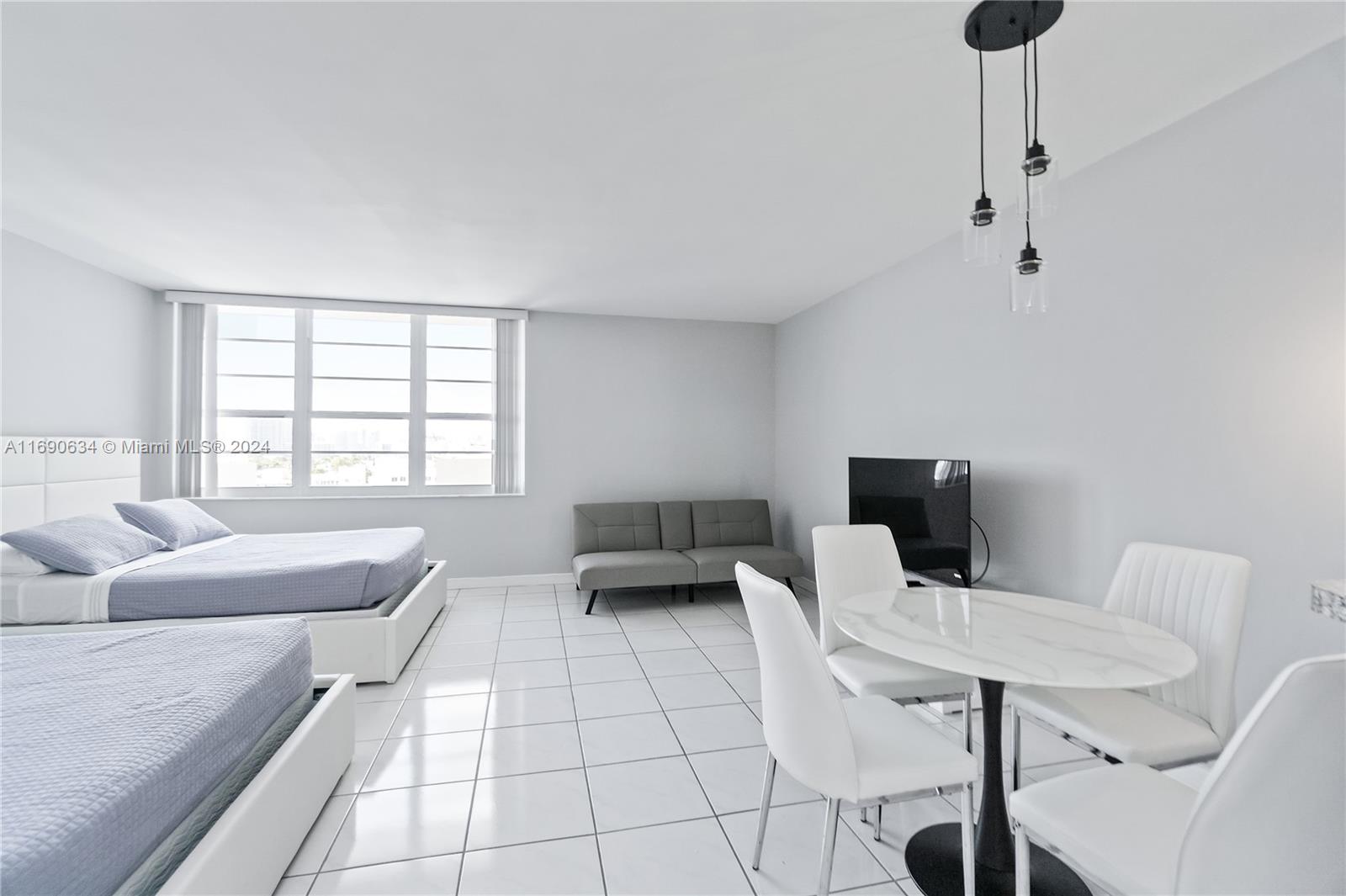 100 Lincoln Road, Unit 1016 Miami Beach, FL 33139 - Photo 2 of 25 a living room with furniture and a window