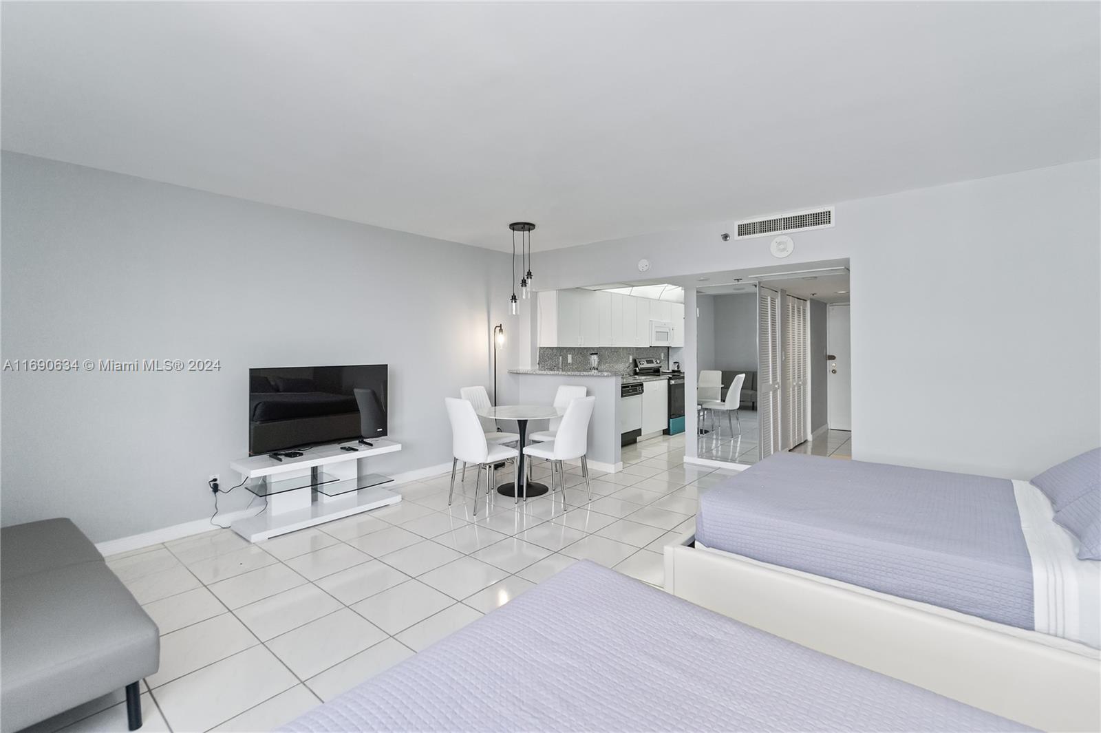 100 Lincoln Road, Unit 1016 Miami Beach, FL 33139 - Photo 4 of 25 a living room with furniture and a flat screen tv