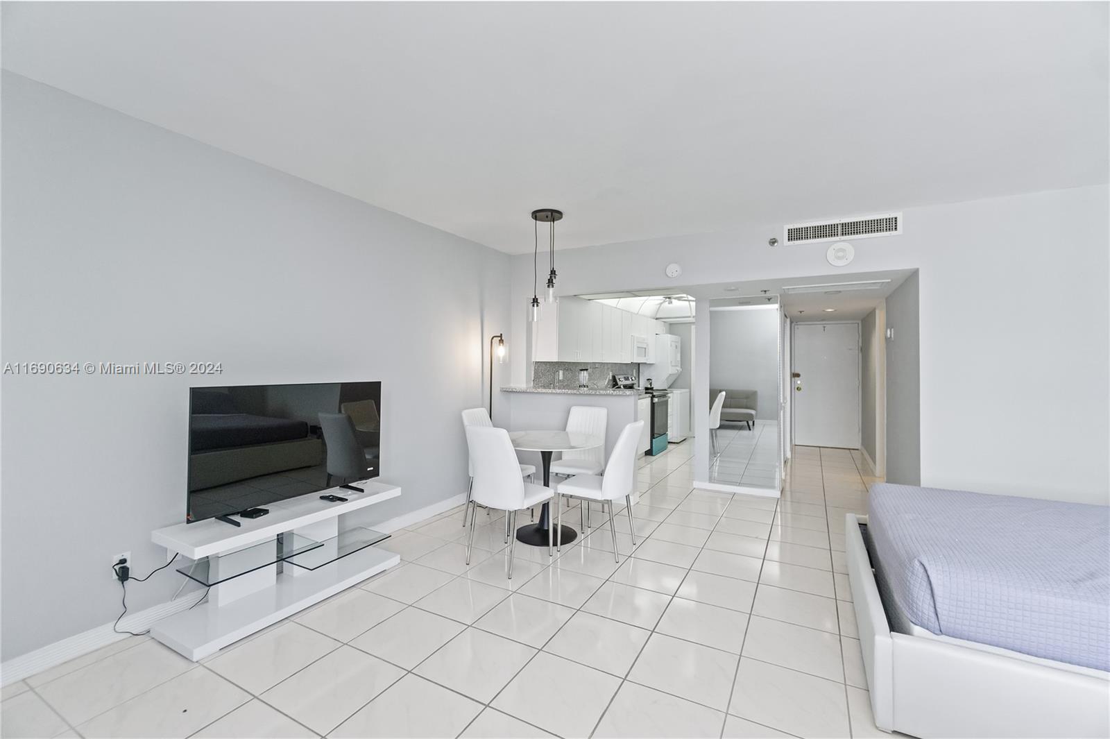 100 Lincoln Road, Unit 1016 Miami Beach, FL 33139 - Photo 6 of 25 a living room with furniture and a flat screen tv