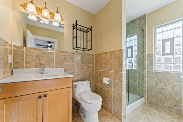 a bathroom with a sink toilet and shower