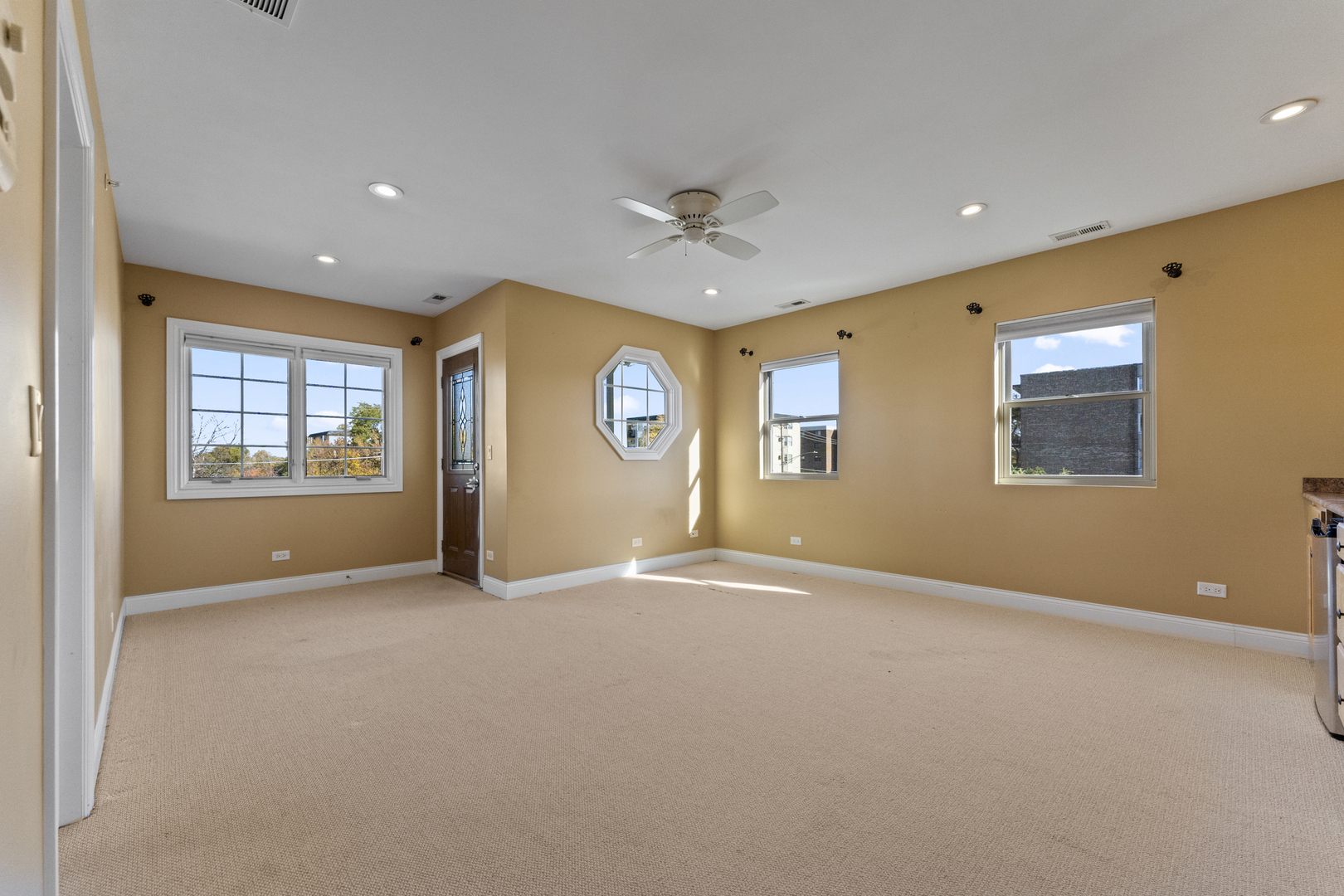 5533 Lincoln Avenue Morton Grove, IL 60053 - Photo 18 of 40 an empty room with windows and ceiling fan