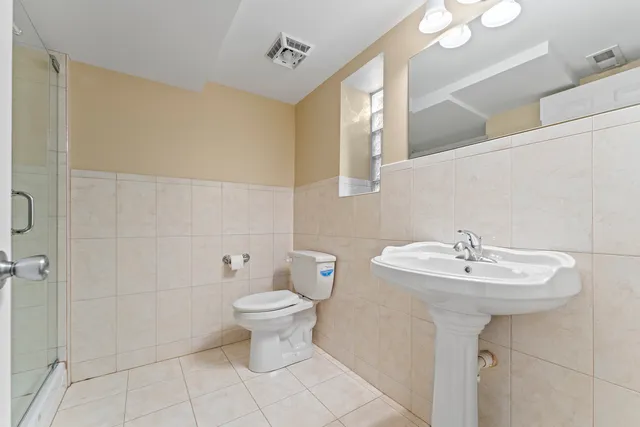 a bathroom with a sink a toilet and mirror