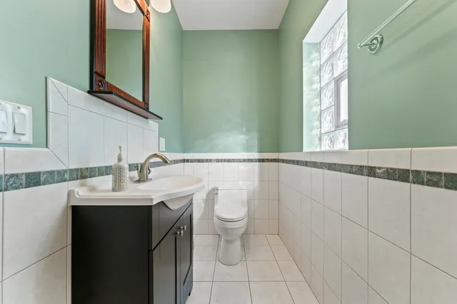 a bathroom with a sink a toilet and mirror