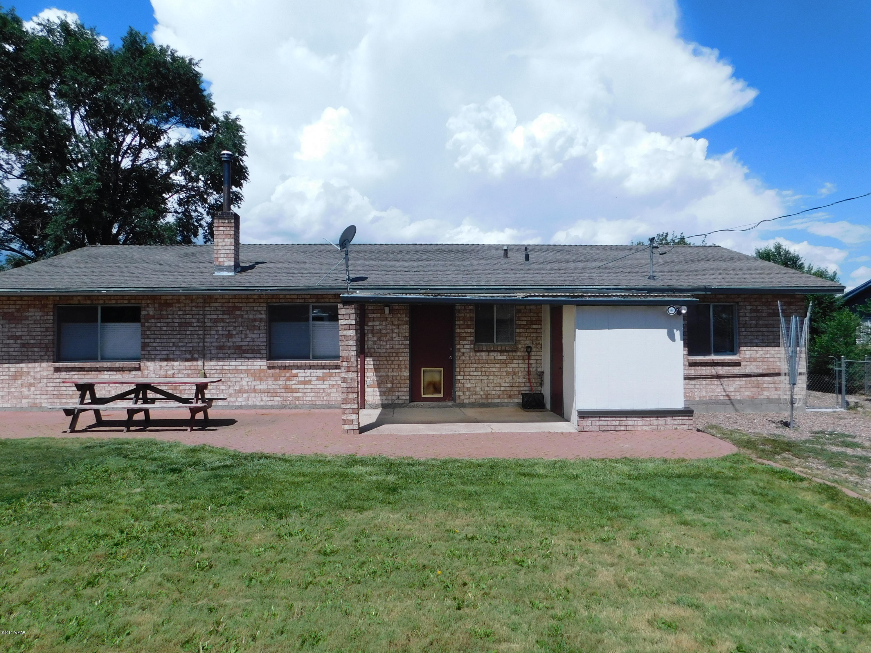 353 Brant Street Eagar, AZ 85925 - Photo 22 of 23 a front view of a house with a garden and sitting area