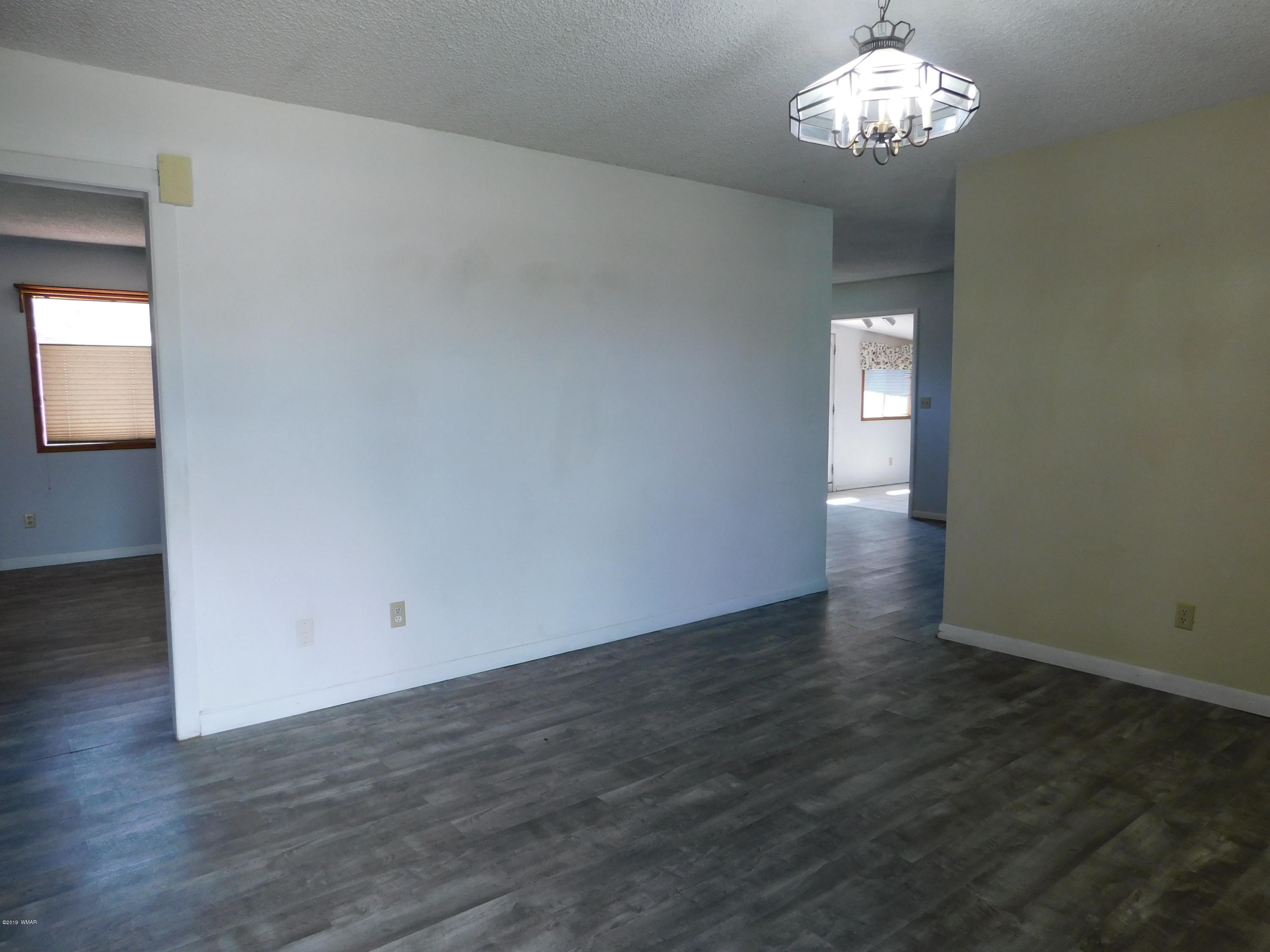 353 Brant Street Eagar, AZ 85925 - Photo 4 of 23 an empty room with wooden floor and windows
