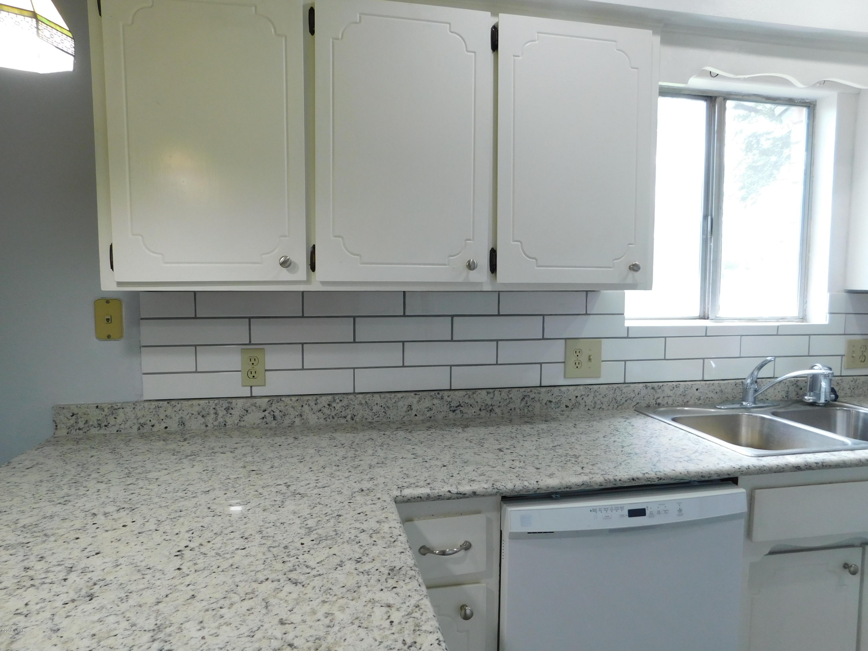 353 Brant Street Eagar, AZ 85925 - Photo 8 of 23 a kitchen with a sink and cabinets