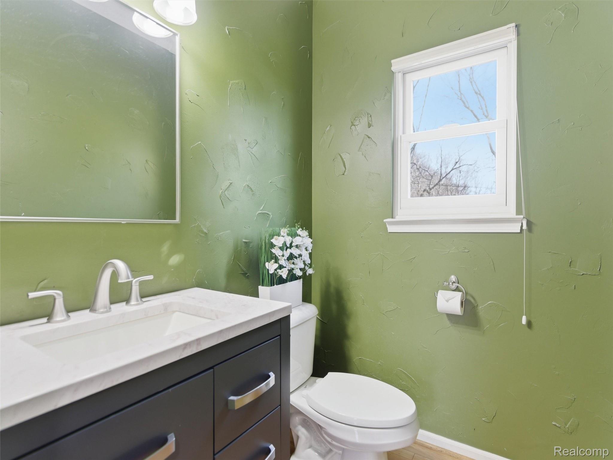 7640 Clintonville Road Clarkston, MI 48348 - Photo 15 of 27 Half bathroom featuring vanity and a textured wall
