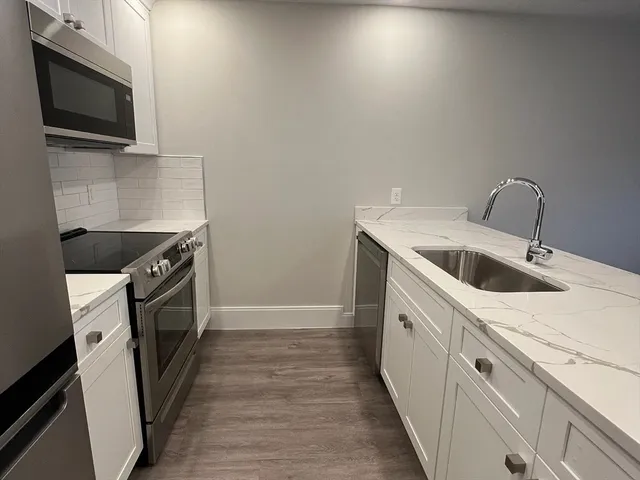 a kitchen with a sink and a microwave