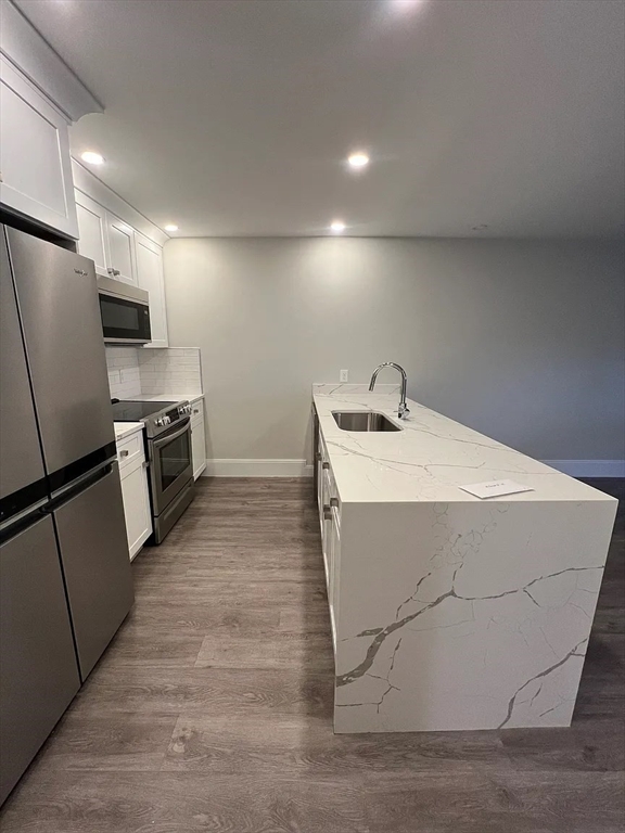 17 Carson Street, Unit 6C Boston, MA 02125 - Photo 6 of 11 a kitchen with stainless steel appliances a refrigerator sink and microwave