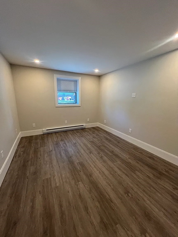 17 Carson Street, Unit 6C Boston, MA 02125 - Photo 10 of 11 a view of an empty room with wooden floor and a window