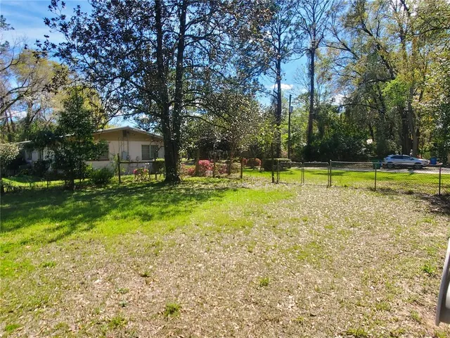 a view of a house with swimming pool and a yard