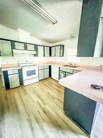 a spacious bathroom with a sink and a large mirror