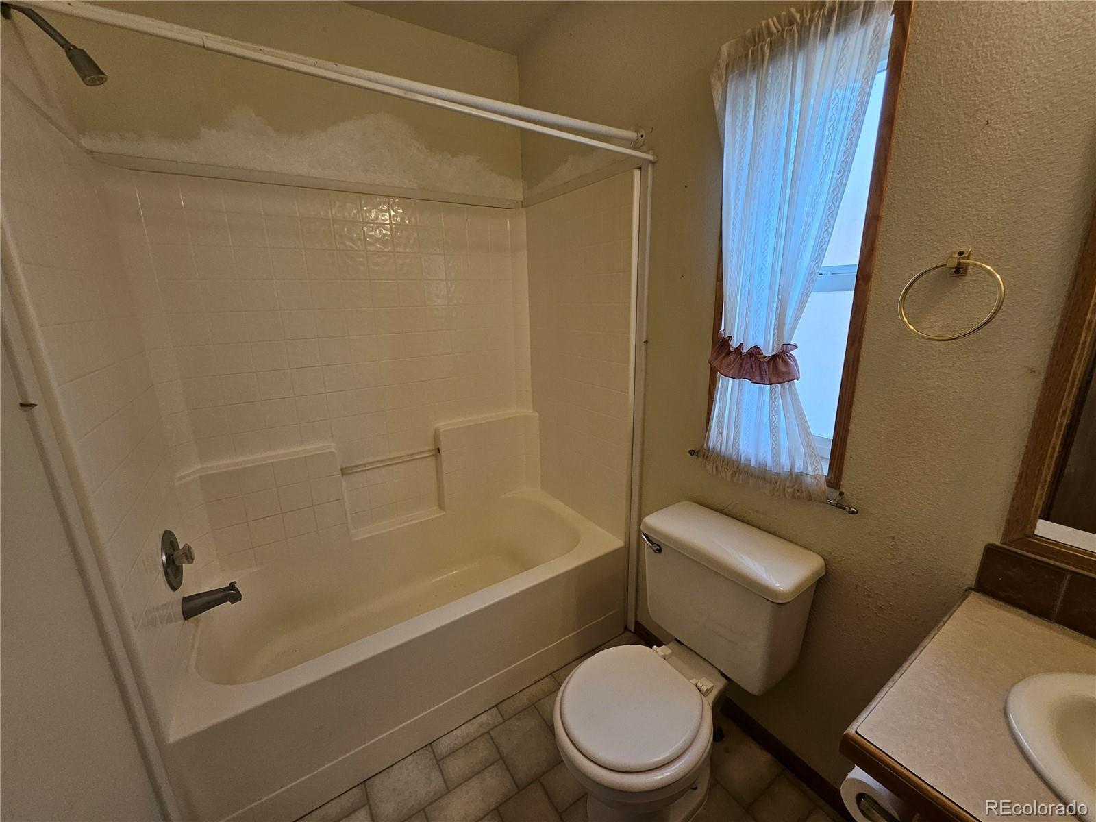 631 Arrowhead Drive Como, CO 80432 - Photo 24 of 45 a white toilet sitting next to a bath tub