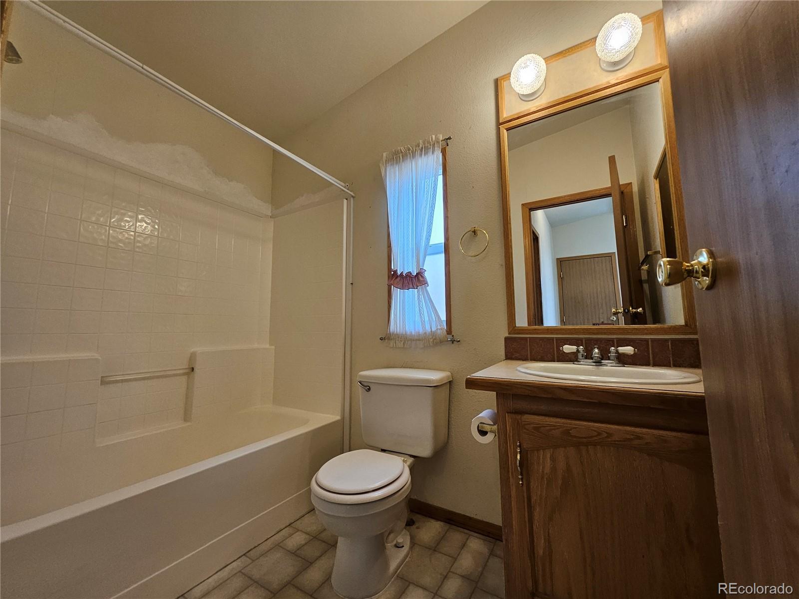 631 Arrowhead Drive Como, CO 80432 - Photo 26 of 45 a bathroom with a sink a toilet and shower a mirror