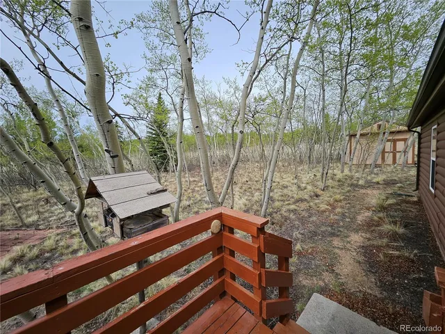 a view of a wooden chairs in a backyard