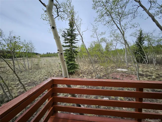 a view of balcony with wooden floor and lake view