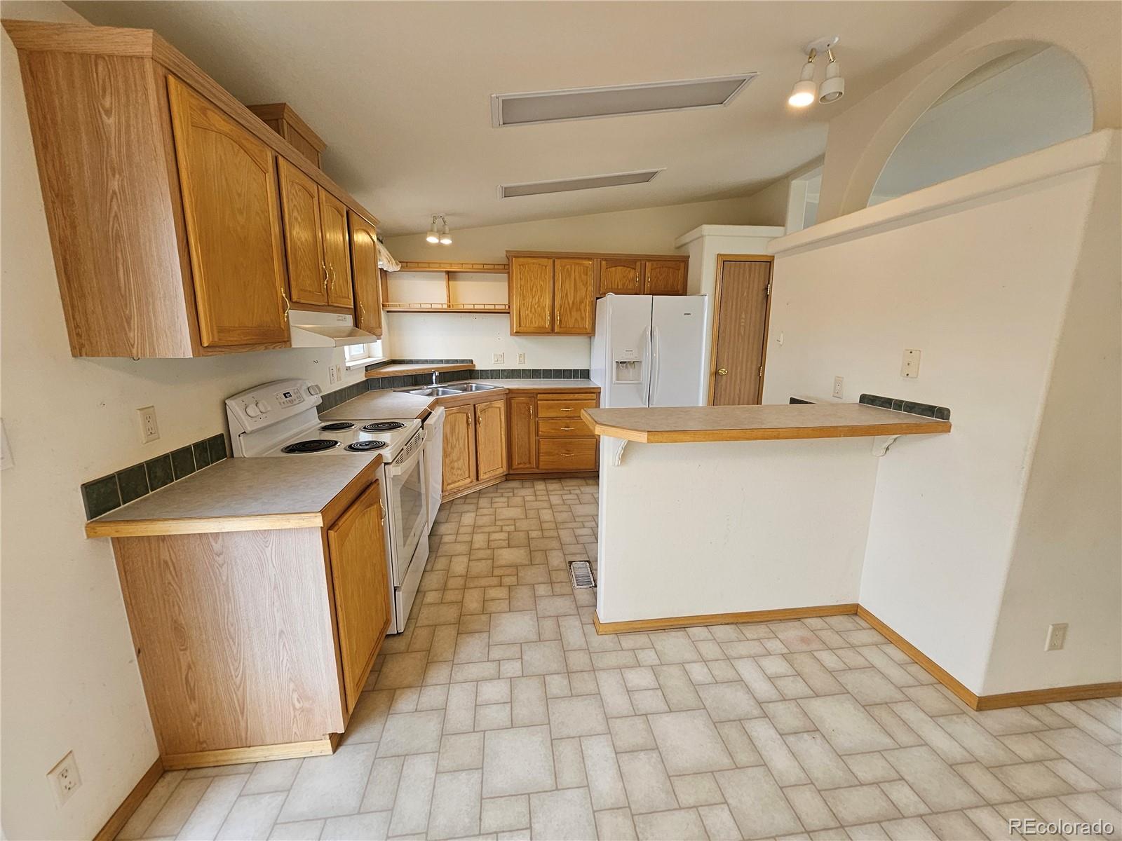 631 Arrowhead Drive Como, CO 80432 - Photo 6 of 45 a kitchen with a sink a stove top oven a counter space and cabinets