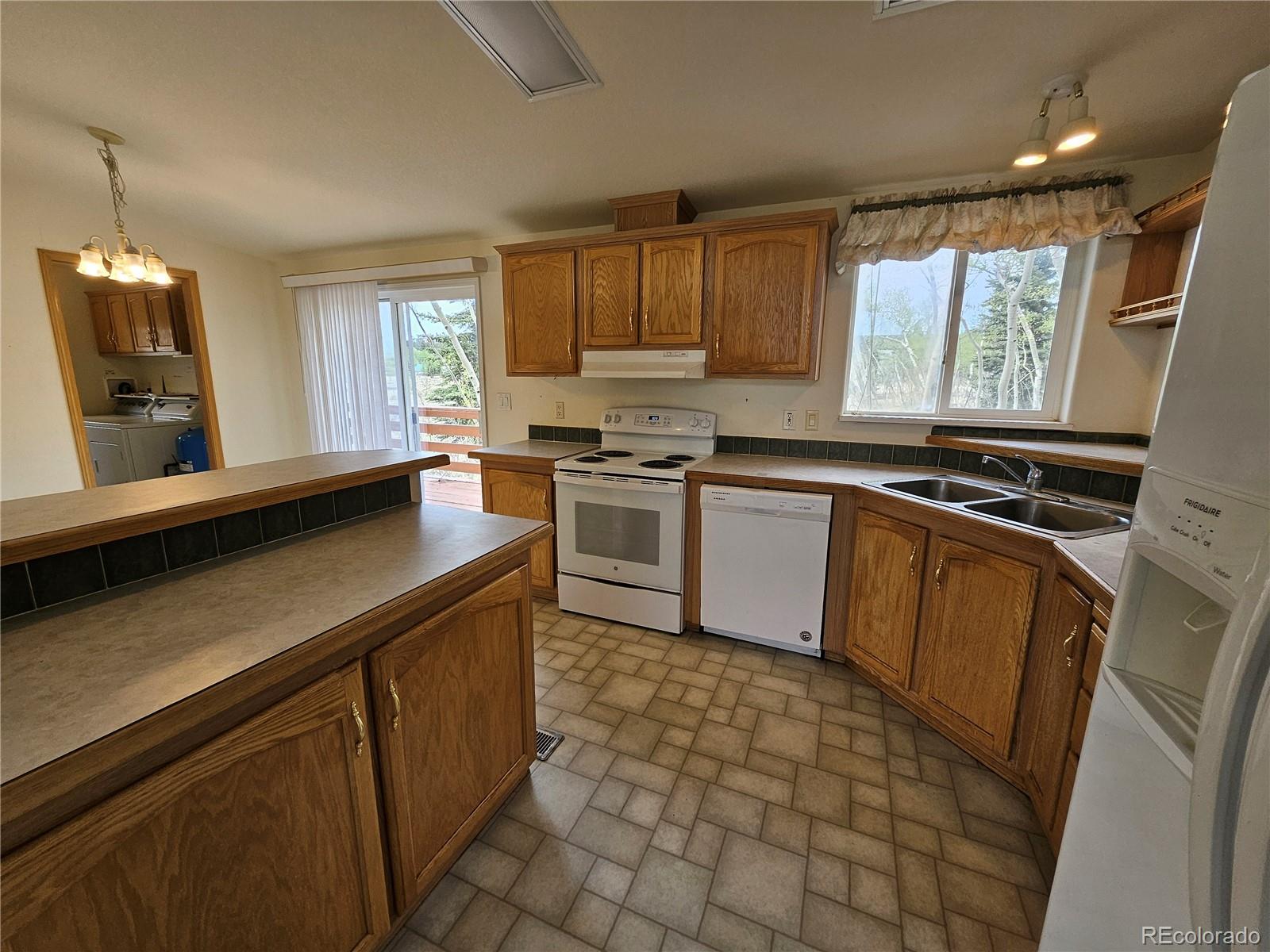 631 Arrowhead Drive Como, CO 80432 - Photo 7 of 45 a kitchen with a sink stove and cabinets