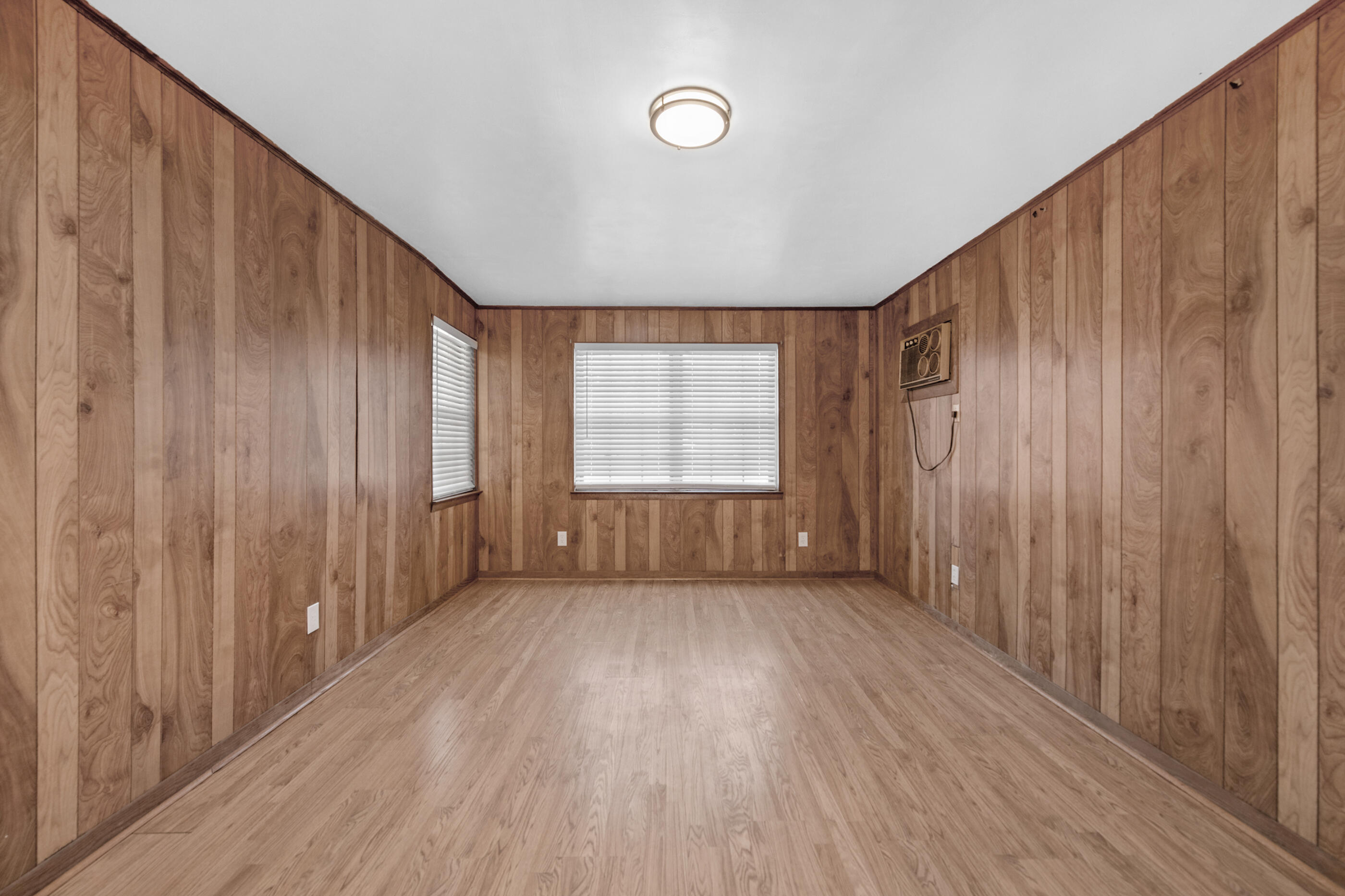 235 Deluna Road Southwest Fort Walton Beach, FL 32548 - Photo 11 of 29 a view of an empty room with wooden floor and a window