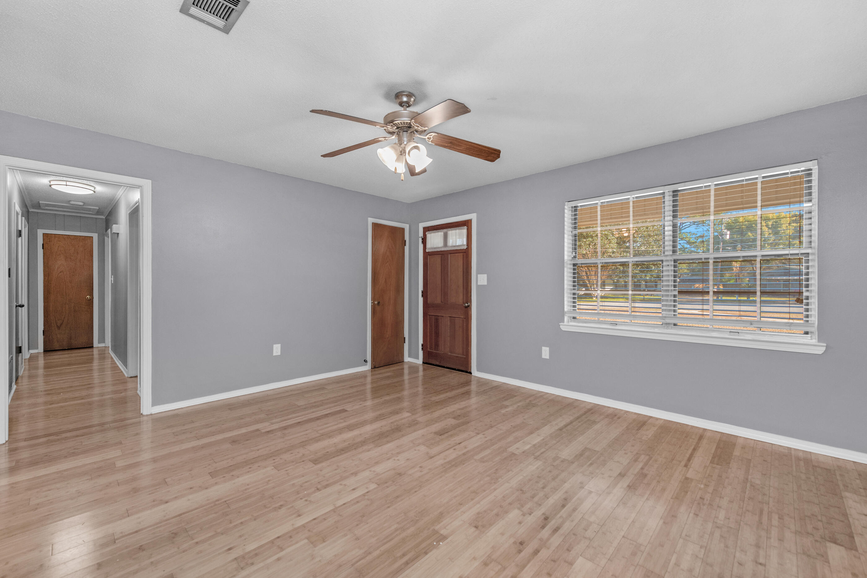 235 Deluna Road Southwest Fort Walton Beach, FL 32548 - Photo 15 of 29 a view of an empty room with a window and wooden floor