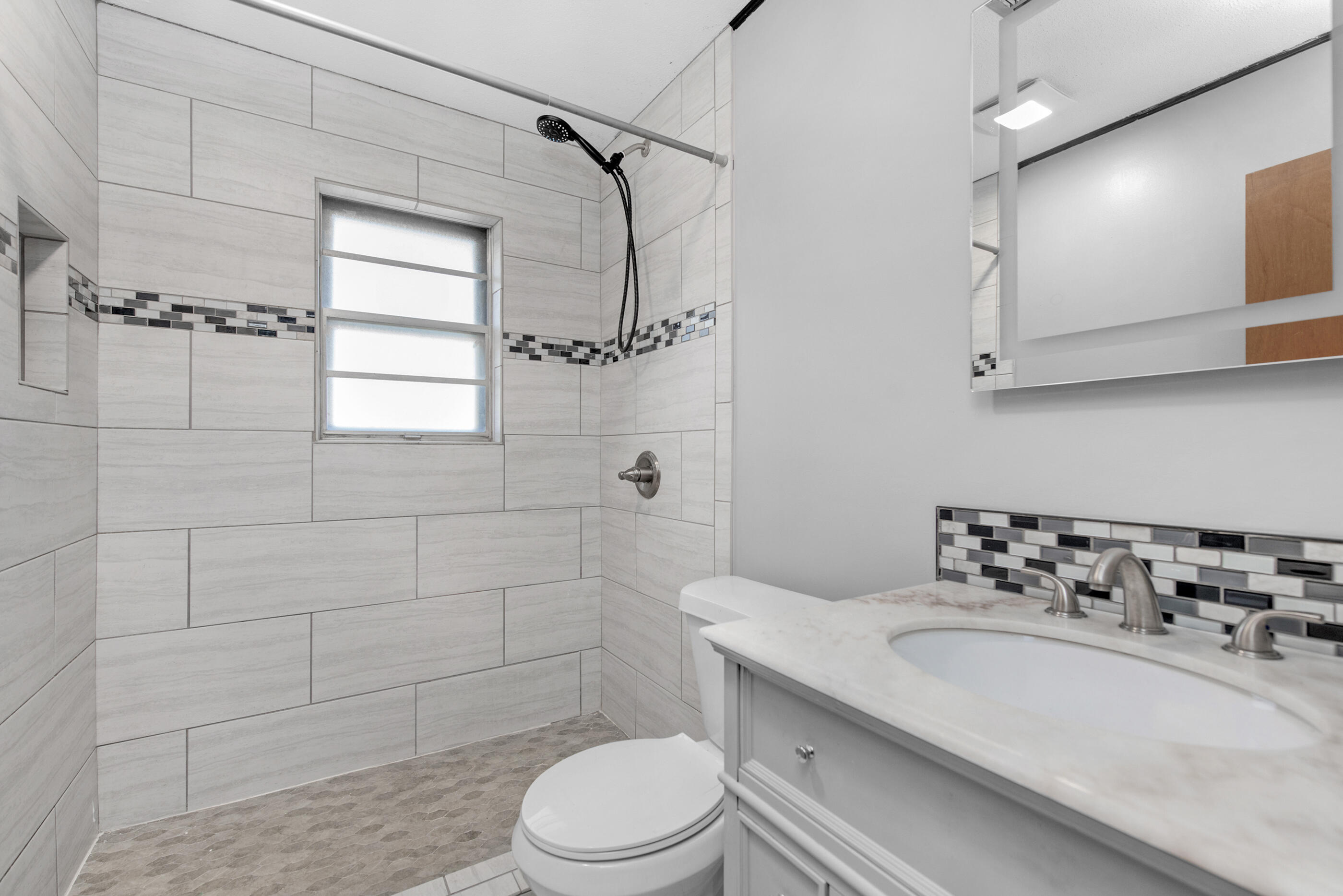 235 Deluna Road Southwest Fort Walton Beach, FL 32548 - Photo 17 of 29 a bathroom with a sink a toilet and shower