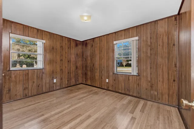 a view of an empty room with wooden floor