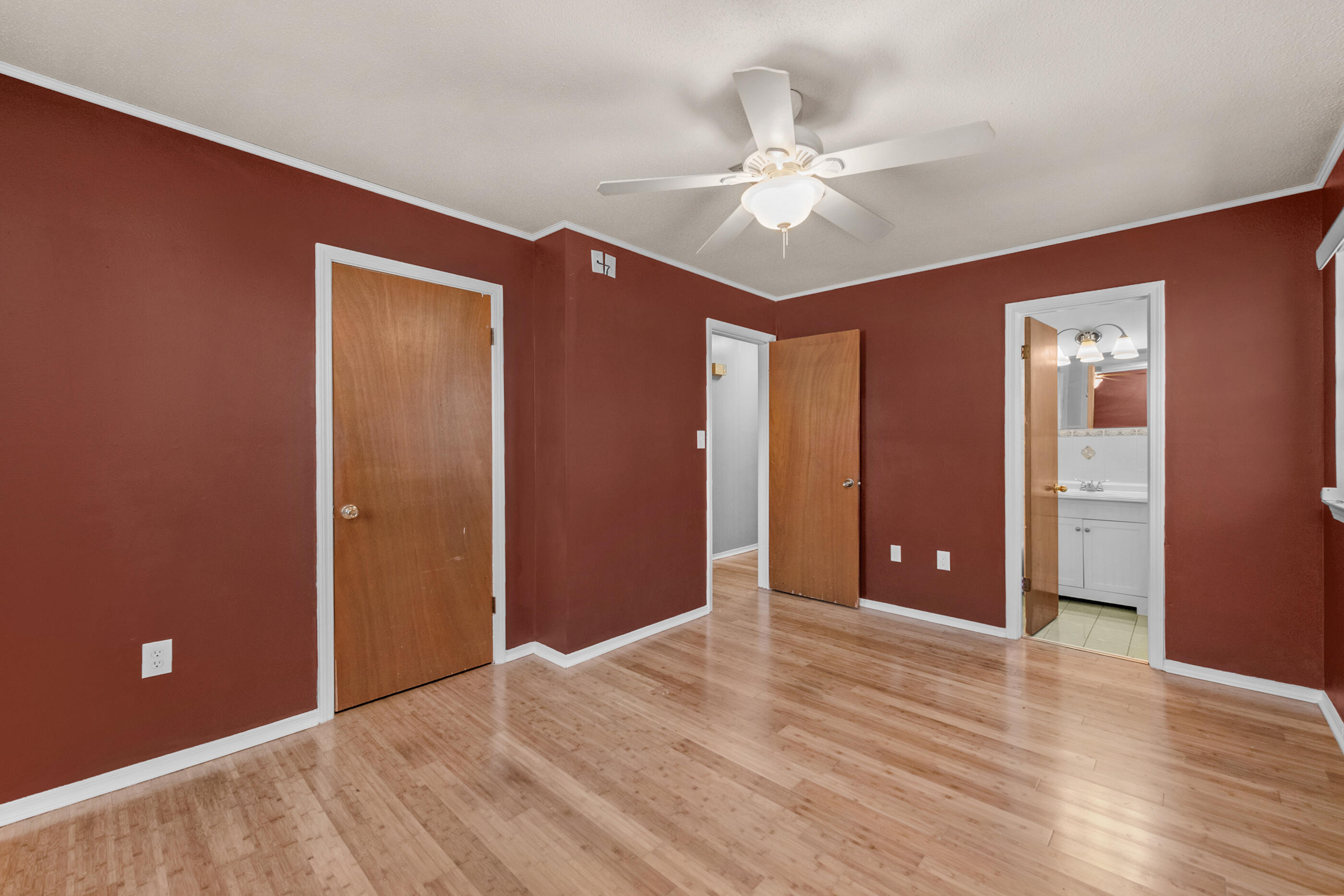 235 Deluna Road Southwest Fort Walton Beach, FL 32548 - Photo 22 of 29 a view of an empty room with wooden floor and a ceiling fan