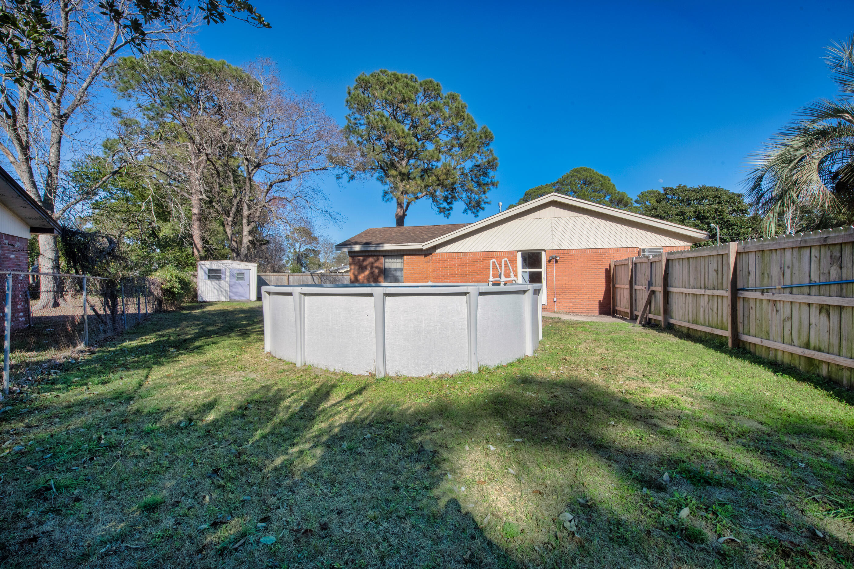 235 Deluna Road Southwest Fort Walton Beach, FL 32548 - Photo 25 of 29 a view of a yard with wooden fence