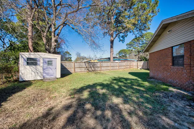 a front view of house with yard and trees