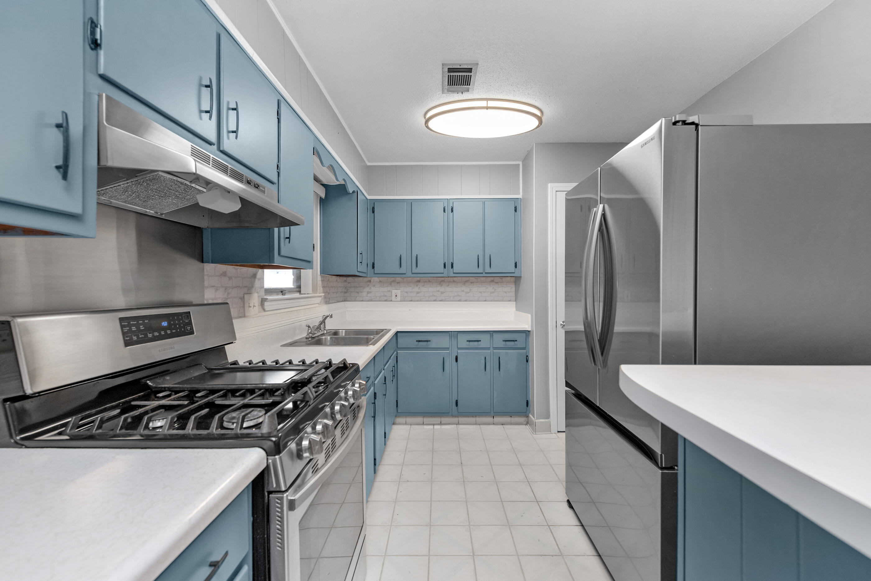 235 Deluna Road Southwest Fort Walton Beach, FL 32548 - Photo 5 of 29 a kitchen with stainless steel appliances a sink stove and refrigerator