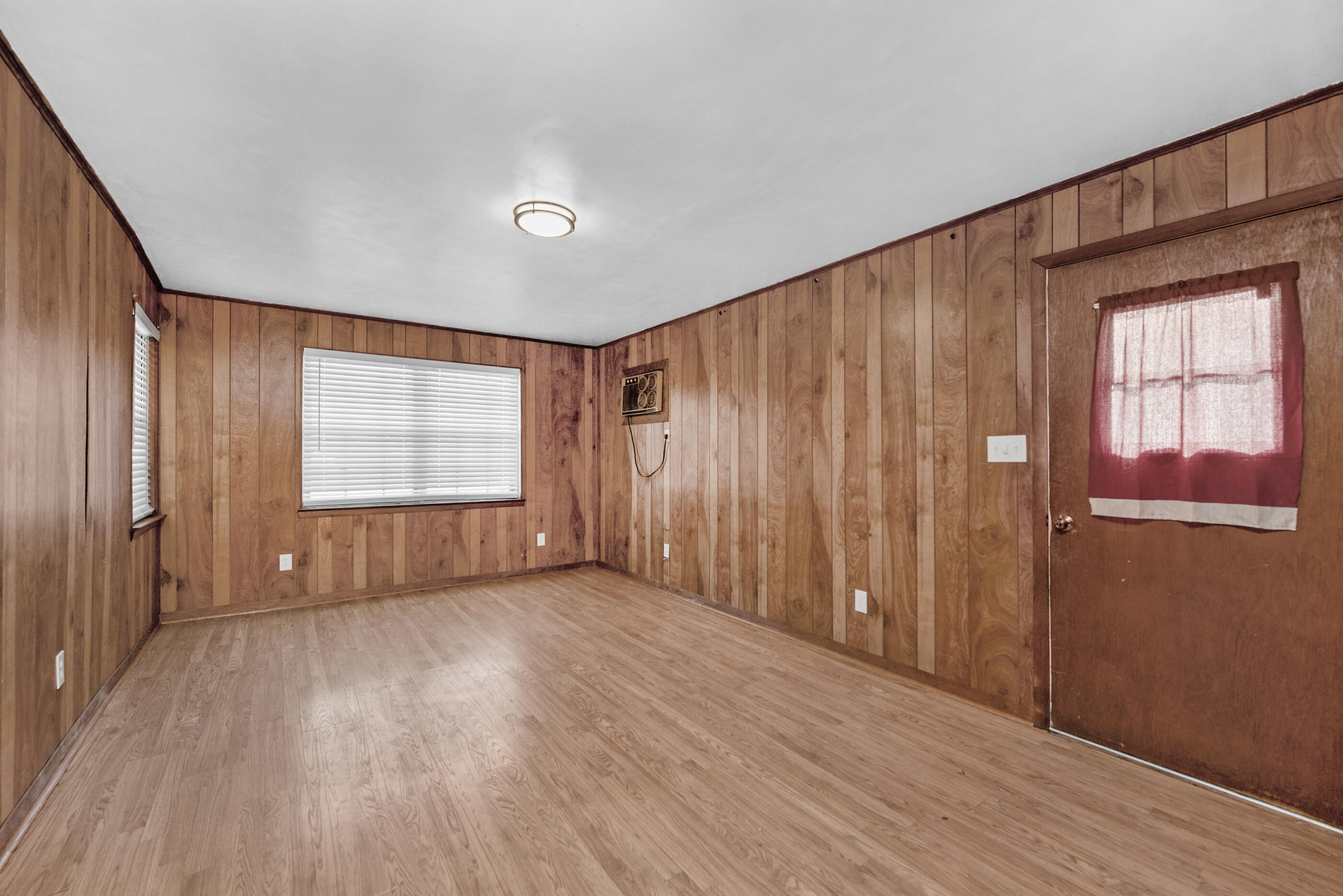 235 Deluna Road Southwest Fort Walton Beach, FL 32548 - Photo 10 of 29 an empty room with wooden floor and windows