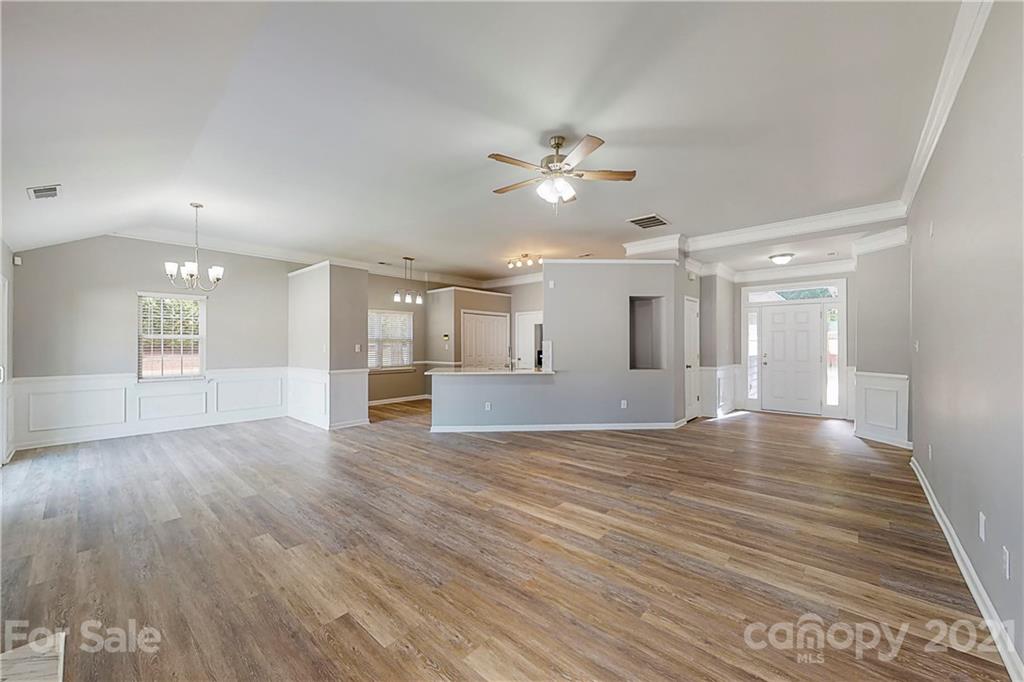 15387 Leslie Brooke Road Huntersville, NC 28078 - Photo 14 of 37 a view of an empty room with wooden floor and a ceiling fan