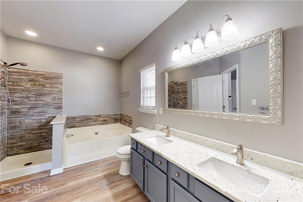 15387 Leslie Brooke Road Huntersville, NC 28078 - Photo 19 of 37 a bathroom with a sink double vanity granite tub and shower