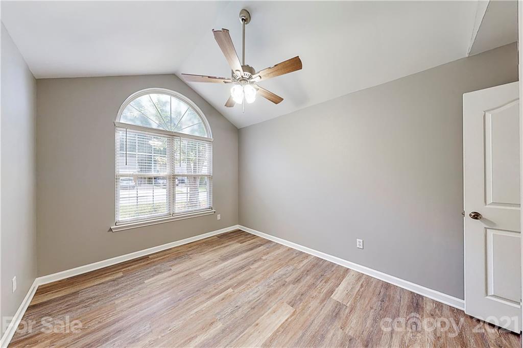 15387 Leslie Brooke Road Huntersville, NC 28078 - Photo 22 of 37 an empty room with wooden floor fan and windows