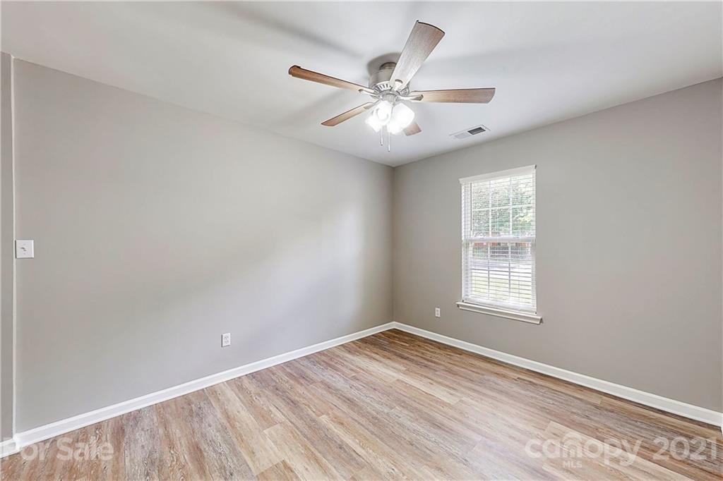 15387 Leslie Brooke Road Huntersville, NC 28078 - Photo 28 of 37 an empty room with wooden floor fan and windows