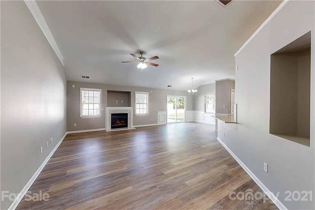 15387 Leslie Brooke Road Huntersville, NC 28078 - Photo 4 of 37 a view of an empty room with window and wooden floor