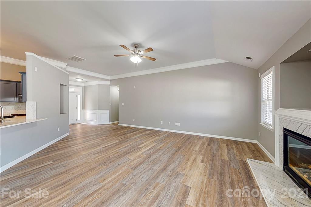 15387 Leslie Brooke Road Huntersville, NC 28078 - Photo 6 of 37 a view of empty room with wooden floor and fan