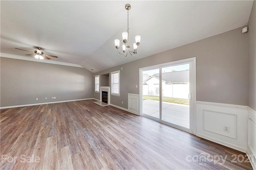 15387 Leslie Brooke Road Huntersville, NC 28078 - Photo 7 of 37 a view of an empty room with a window and wooden floor