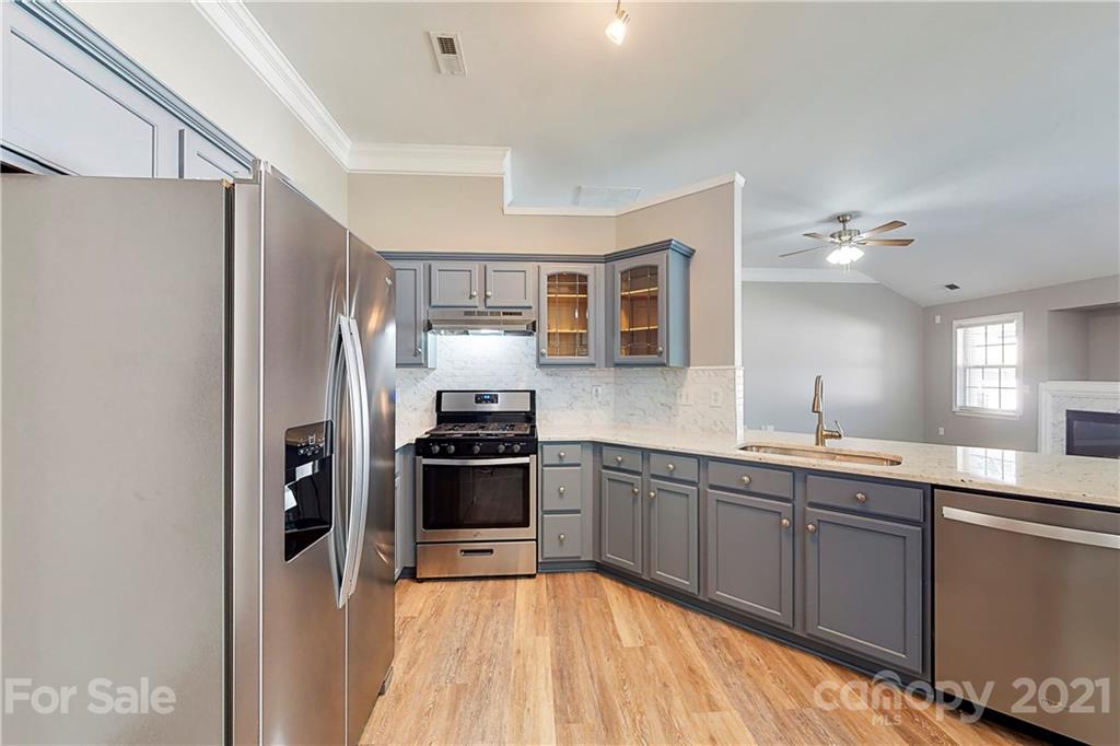 15387 Leslie Brooke Road Huntersville, NC 28078 - Photo 9 of 37 a kitchen with stainless steel appliances granite countertop a refrigerator and a stove top oven