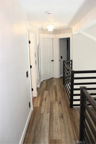 a view of a livingroom with wooden floor and a window
