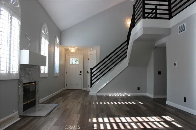 a view of entryway and hall with wooden floor