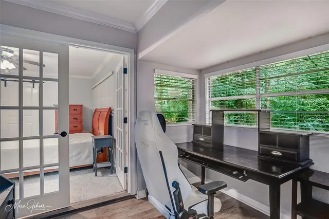 a view of a workspace with furniture and a window