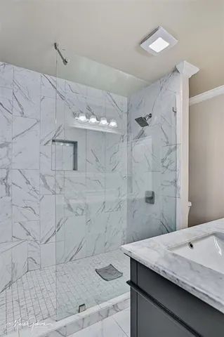 a bathroom with a sink a shower and a mirror