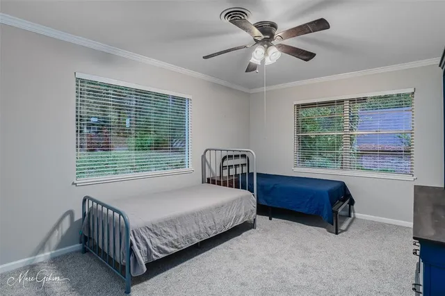 a bedroom with a bed and a large window